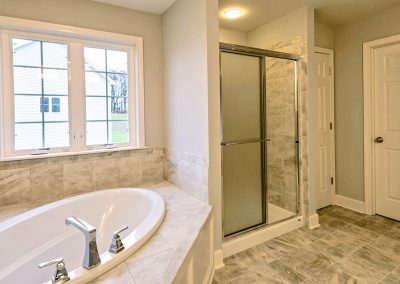 oval tub and tiled shower enclosure