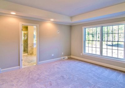 carpeted bedroom with tray ceiling