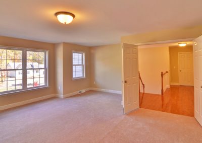 carpeted bedroom with double entry doors