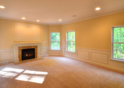 bedroom with fireplace and wall moldings
