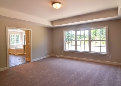 carpeted bedroom with tray ceiling