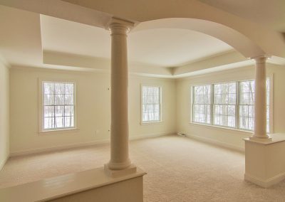 custom arch and columns in carpeted bedroom