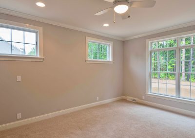 bedroom with transom windows and ceiling fan