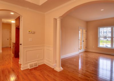 dining room with arched openings and wall molding