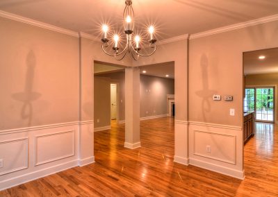 dining room with corner entry and wall molding