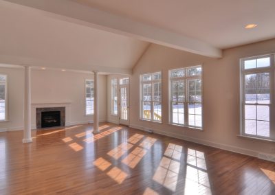 custom extended family room with lots of windows and fireplace