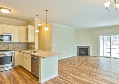 open plan kitchen and living area with corner fireplace