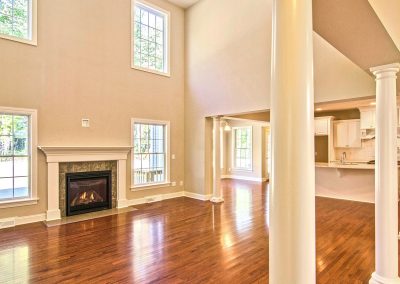 two story family room with columns and fireplace
