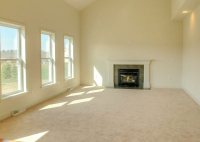 carpeted family room with fireplace