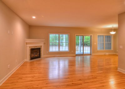 open plan family room with hardwood and corner fireplace