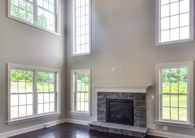 two story room with dark floor and ceiling beams