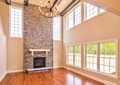 two story stone fireplace and chandelier