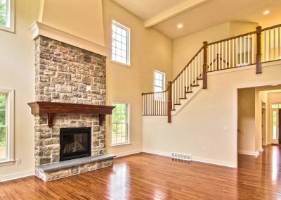 custom stone fireplace and balcony staircase
