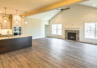 open plan kitchen and family room with fireplace