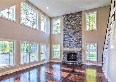 two story stone fireplace and staircase