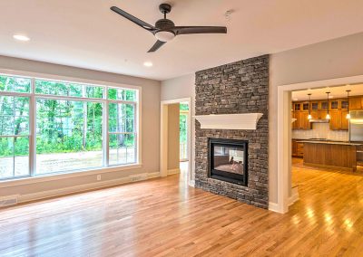 ceiling height stone fireplace with large window