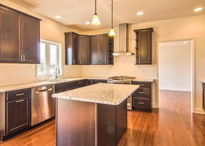 dark kitchen with stainless steel appliances