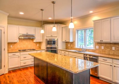 white kitchen with long dark island
