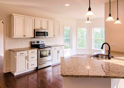 white kitchen with breakfast nook and angled peninsula