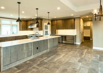 dark custom kitchen with long island and work station