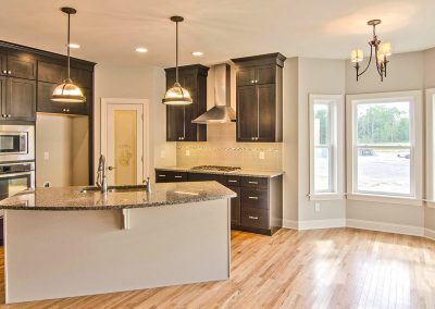 dark cabinets with walk in pantry and bay window