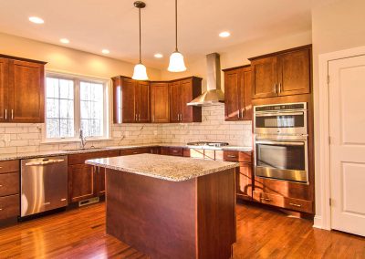 dark kitchen with marble tile and wall oven