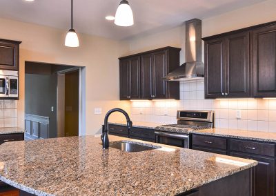 dark kitchen with large curved island