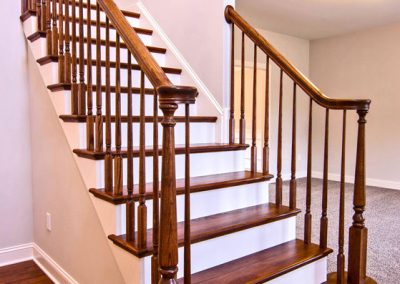 wooden staircase with rounded first step