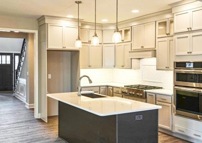 dark and light cabinets with white counters