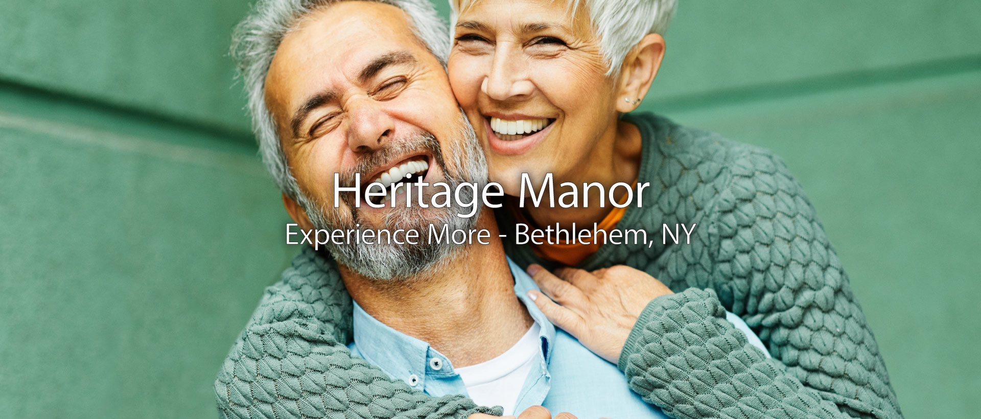 older couple smiling in their kitchen and enjoying life at heritage manor